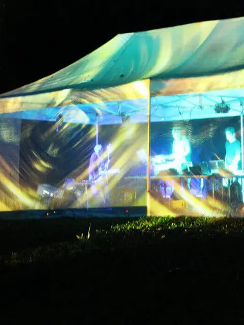Concert - An illuminated tent in which the band plays