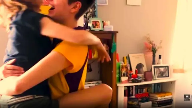 Woman jumps joyfully into the arms of a woman