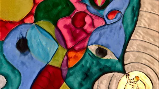 Praying figure in front of a cosmos of colours