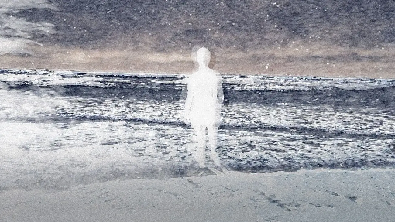 A woman walks on the beach