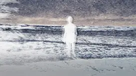 A woman walks on the beach