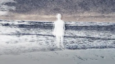 A woman walks on the beach
