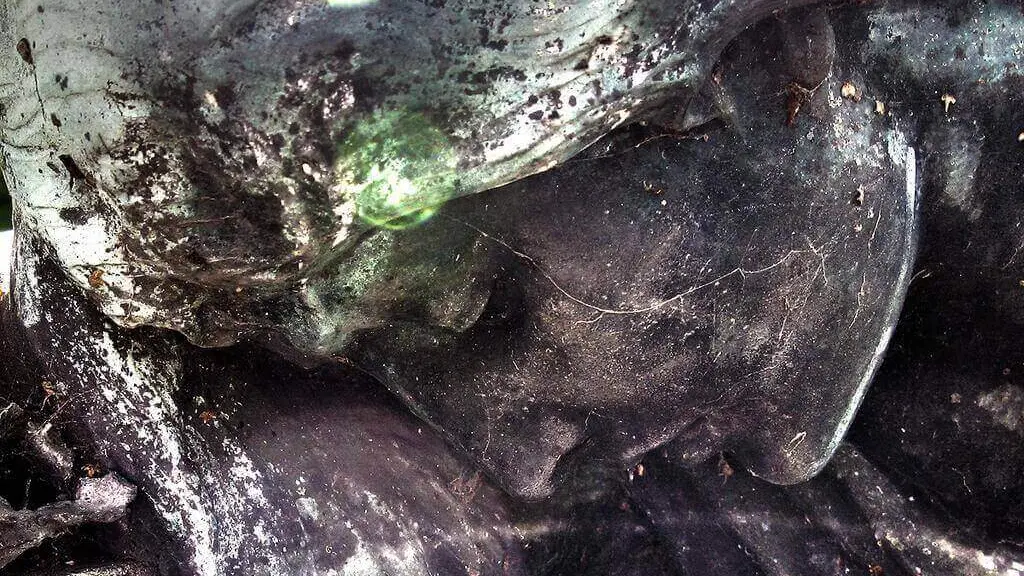 Sculpture of a woman looking down sadly