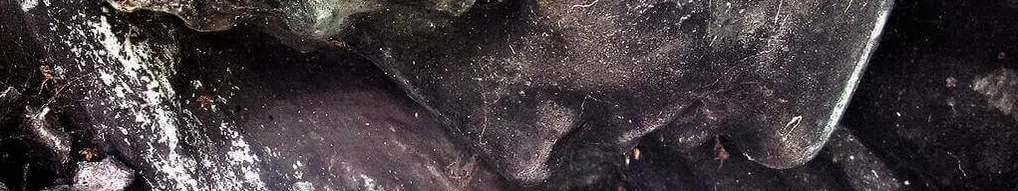 Sculpture of a woman looking down sadly